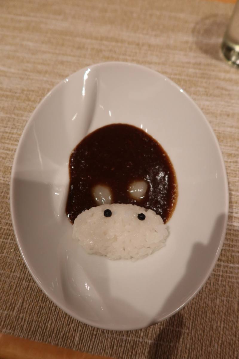 A playfully plated dish of rice and sauce
