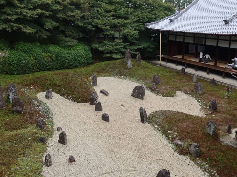 A raked gravel garden with moss and stones